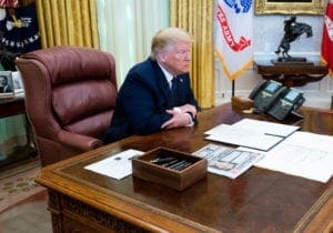U.S. President Donald Trump, with Attorney General William Barr, speaks in the Oval Office before signing an executive order related to regulating social media