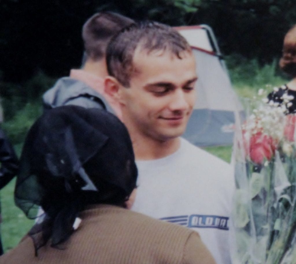 Ivan Teleguz holding flowers at his sister’s baptism.