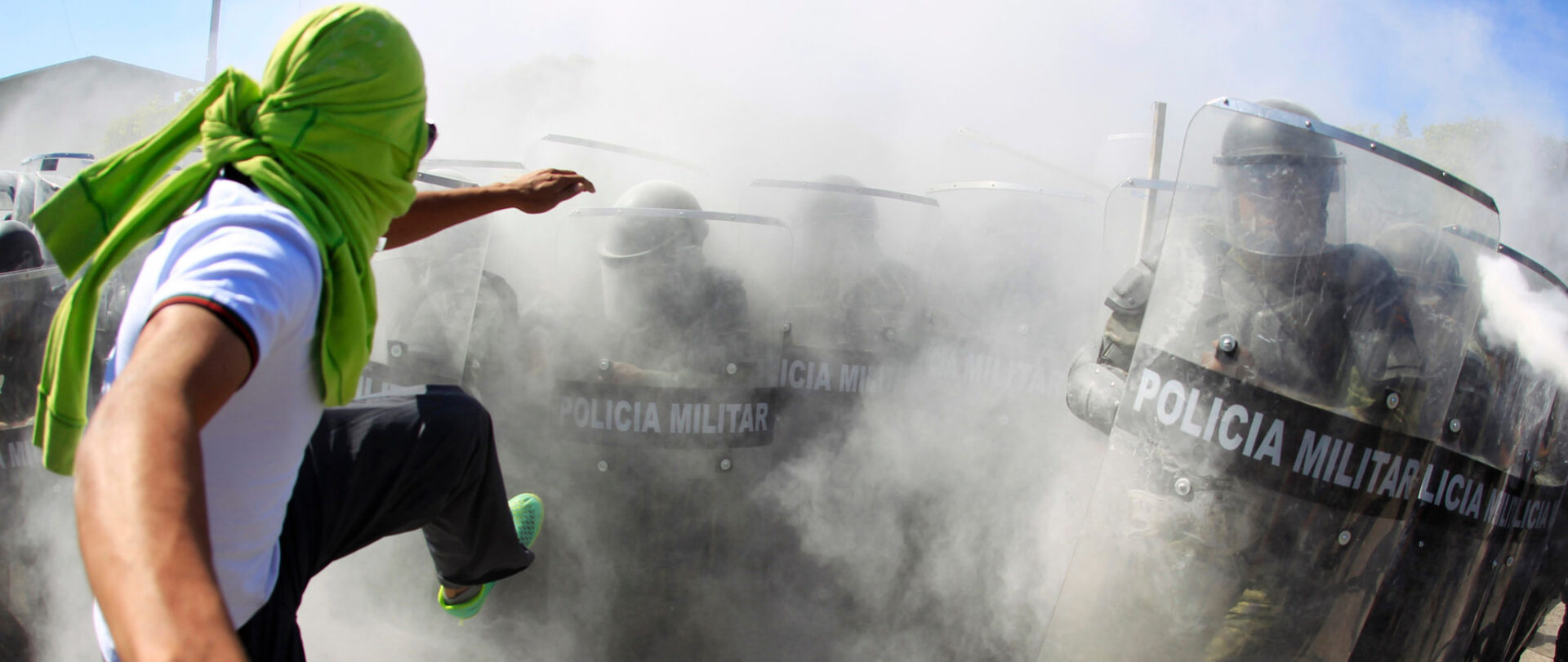 225395_activist_kicks_the_shields_of_the_military_police_officers_during_a_demonstration_in_the_military_zone_of_the_27th_infantry_battalion_in_iguala_guerrero.jpg