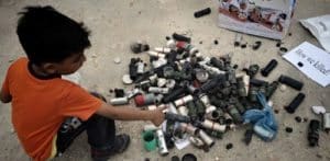 Bahraini boy with tear gas cannisters