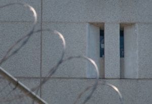 A prisoner shines a torch from the main ICE detention center in downtown Los Angeles