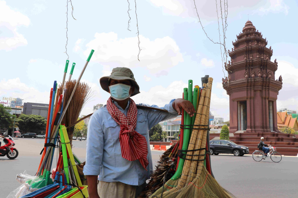 A vendor is wearing a mask in Cambodia