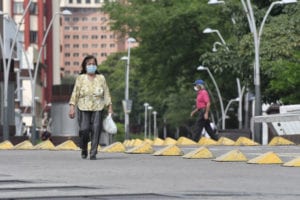 Woman walks with a mask on