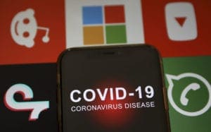 In this photo illustration a smartphone screen reading "Covid 19"