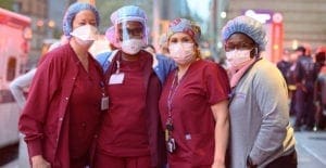 Medical workers stand outside NYU Langone Health hospital as people applaud to show their gratitude to medical staff and essential workers during the coronavirus pandemic on April 29, 2020 in New York City