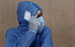 MUMBAI, INDIA - 2020/07/08: Healthcare worker wearing protective gear, adjusts his glasses during the covid 19 crisis.