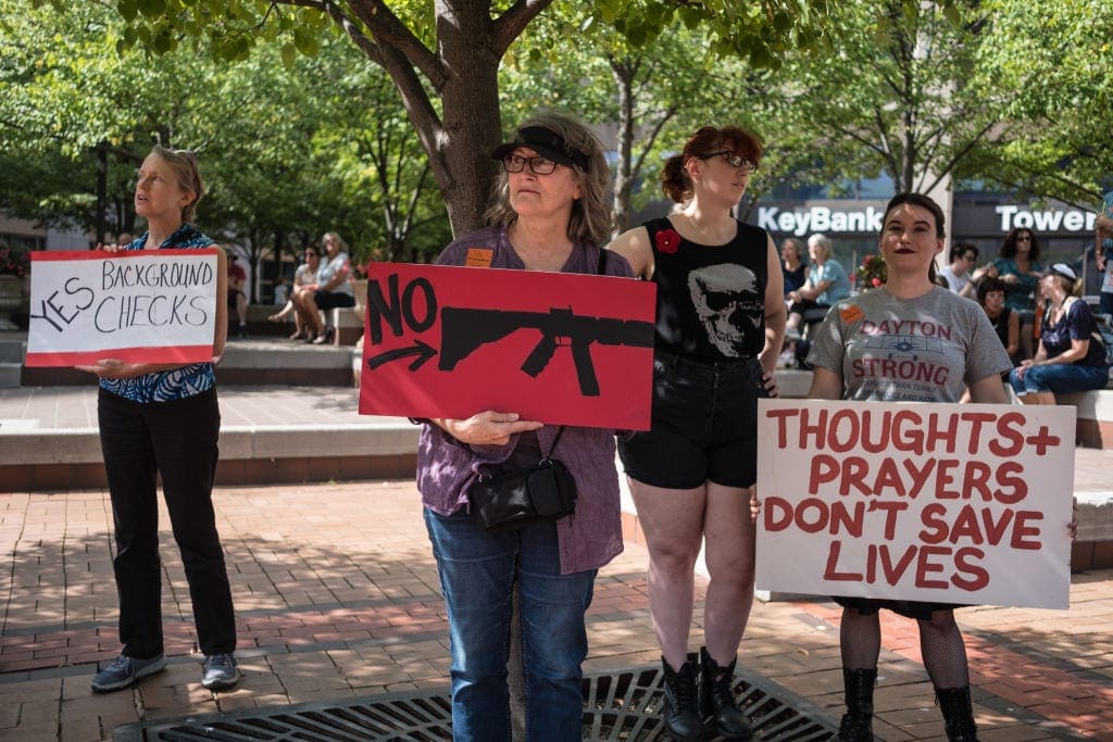 DAYTON, OHIO, UNITED STATES - 2019/08/21: Women hold placards during a gun reform rally that was held in Dayton, Ohio in the wake of a mass shooting at the area earlier this month that left 9 dead and 27 wounded. (Photo by Megan Jelinger/SOPA Images/LightRocket via Getty Images)