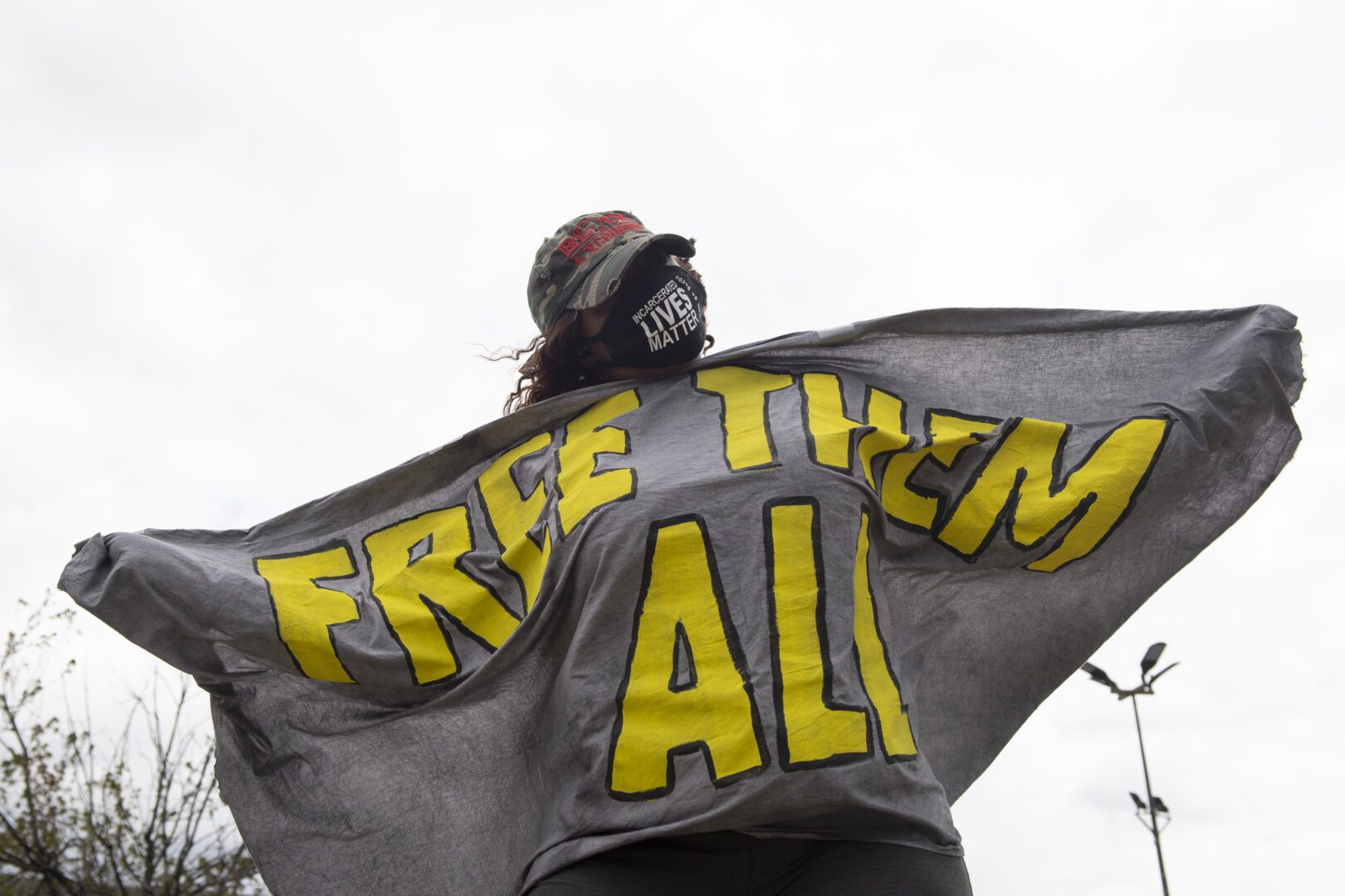 Woman holds big sign that reads: Free them all