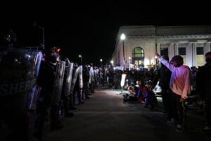 KENOSHA, WISCONSIN, USA - AUGUST 25: Protestors confront police in front of the Kenosha County Courthouse during a third night of protests on August 25, 2020 over the shooting of a black man Jacob Blake by police officer in Wisconsin, United States. Wisconsin expands Natâl Guard presence amid unrest. Governor declares state of emergency as civil unrest in Kenosha continues after Black man was shot several times at close range in the back during an encounter with a police officer on Sunday. (Photo by Tayfun Coskun/Anadolu Agency via Getty Images)