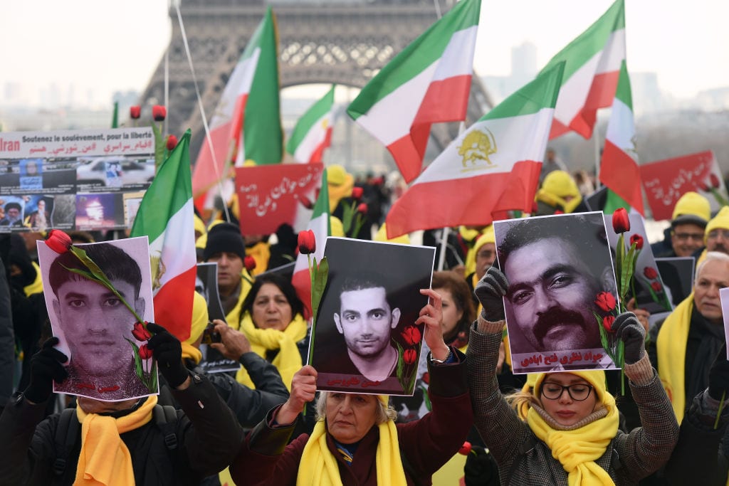 Demonstrators in Paris hold photos of Iran