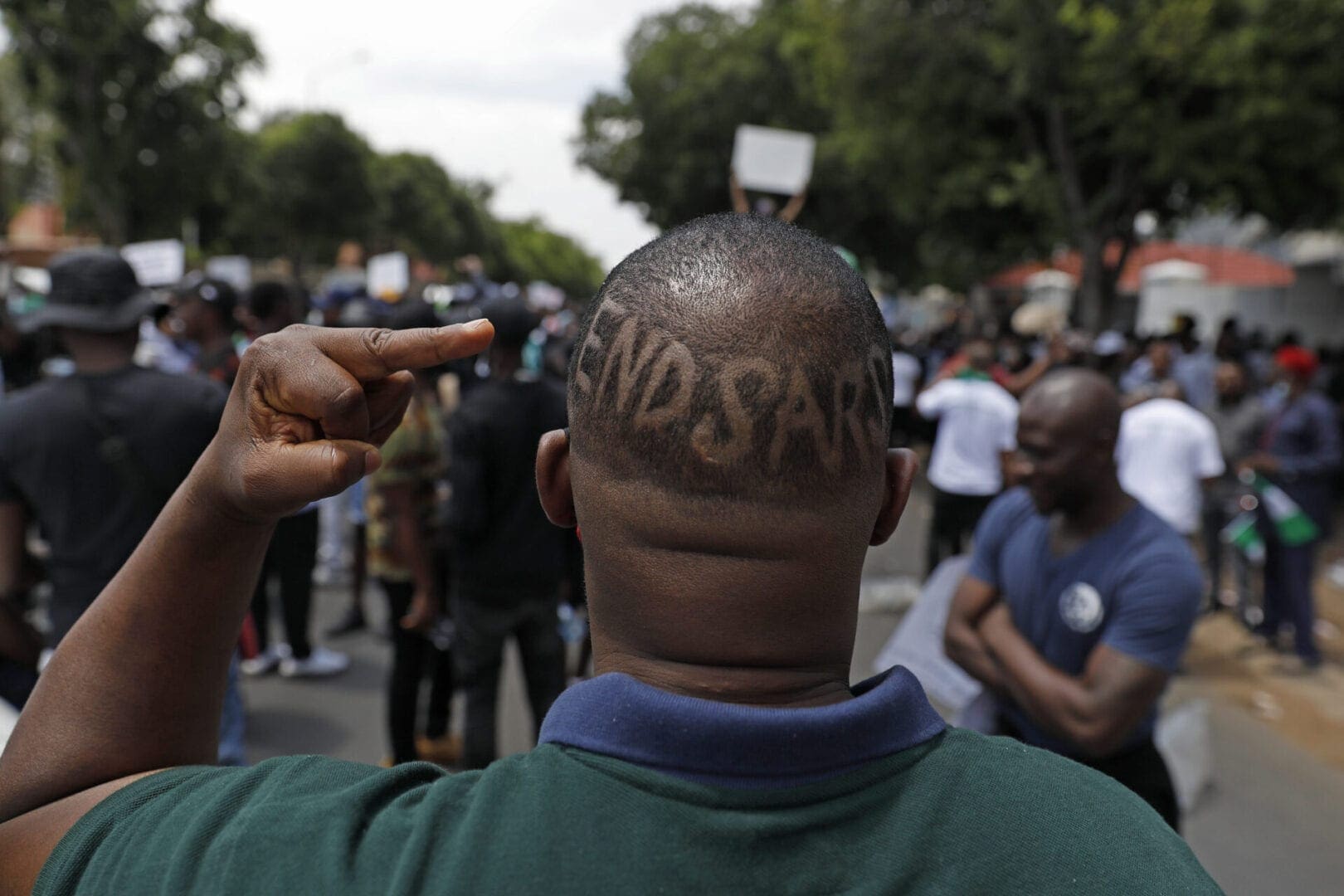The words EndSars are shaved onto a protestor's head