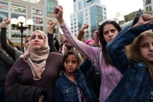 Women and girls in New York protest and hold up their fists