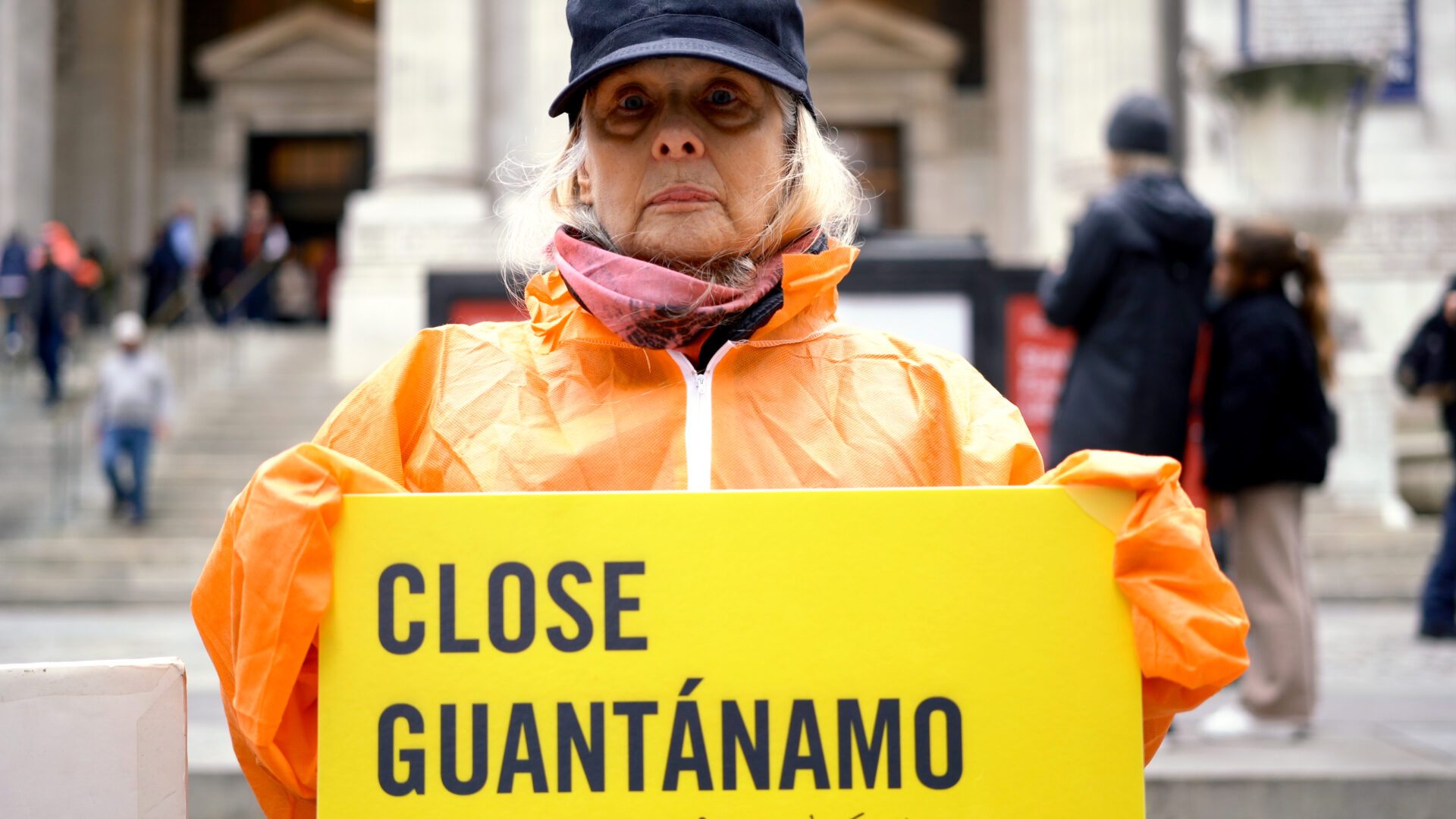 Amnesty International protestor holding Close Guantanamo sign