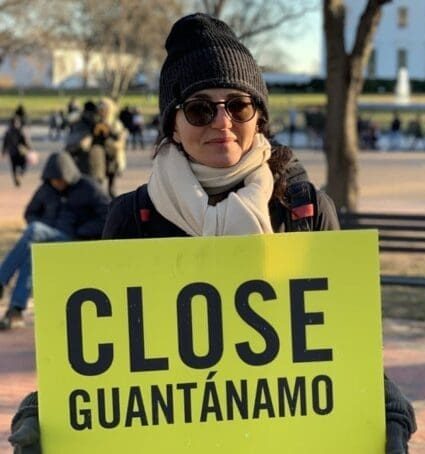person holds a Close Guantanamo sign