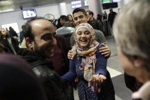 Woman smiled with her brother at the airport
