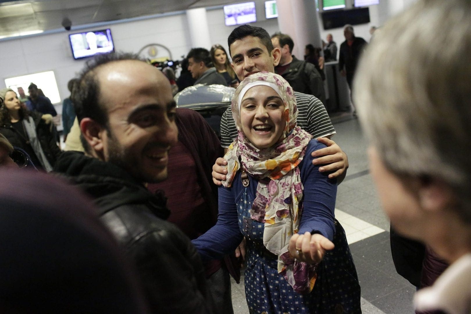 Woman smiled with her brother at the airport