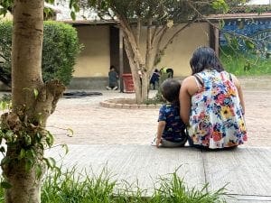 Mother sits with child