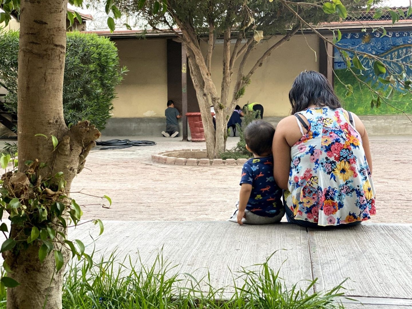 Mother sits with child