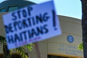 Sign that says "Stop Deporting Haitians!"