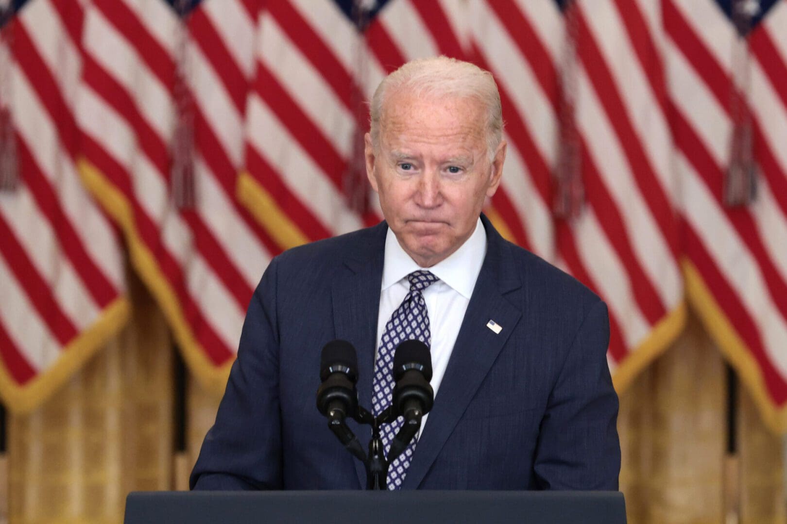 Biden stands in front of United States flag