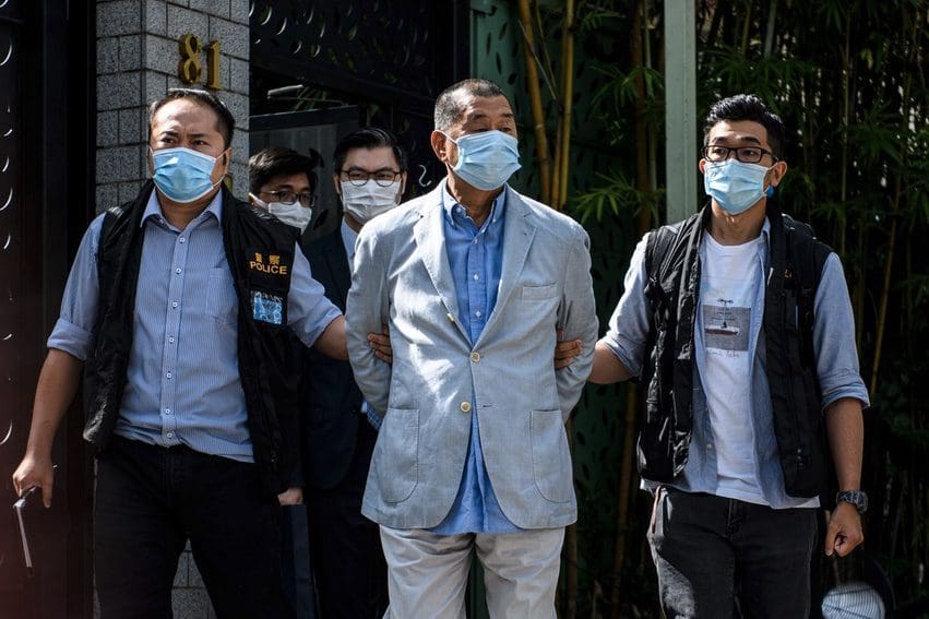Police leading Jimmy Lai from his home after he was arrested under the National Security Law on August 10, 2020.