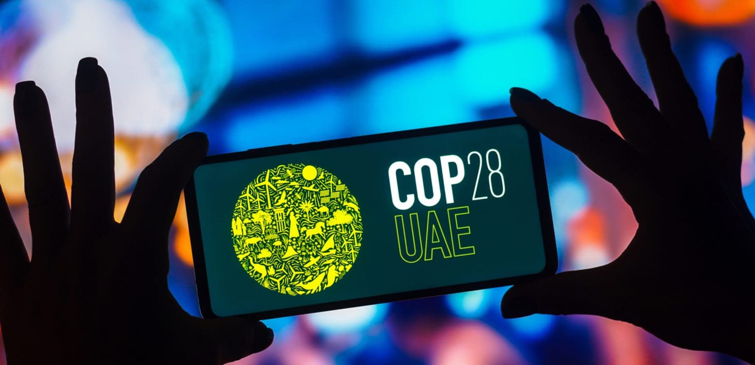 COP28 climate summit logo on phone
