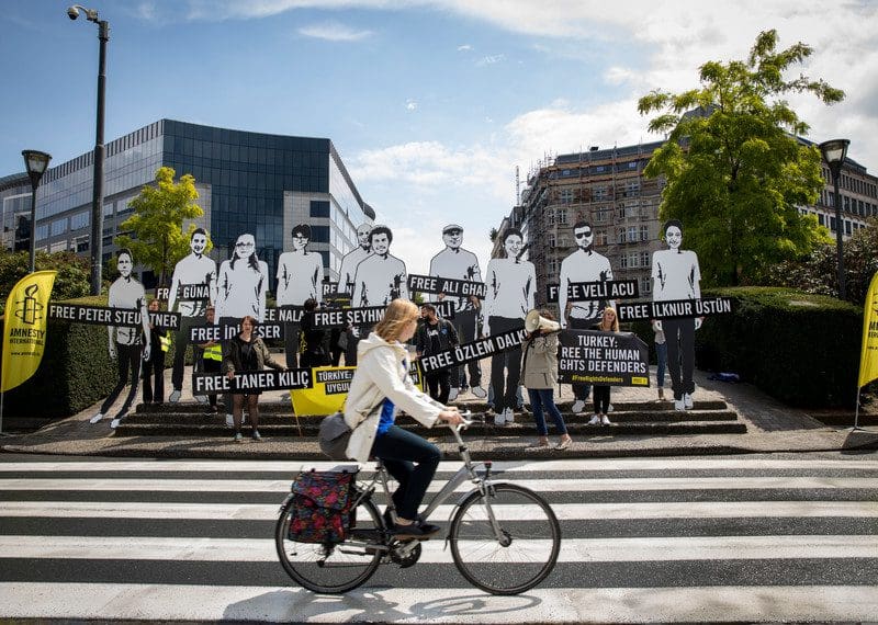 Activists protest outside the European Commission building in Brussels to urgently raise awareness of jailed human rights defenders – including Amnesty International’s Turkey Director and Chair, Idil Eser and Taner Kılıç.