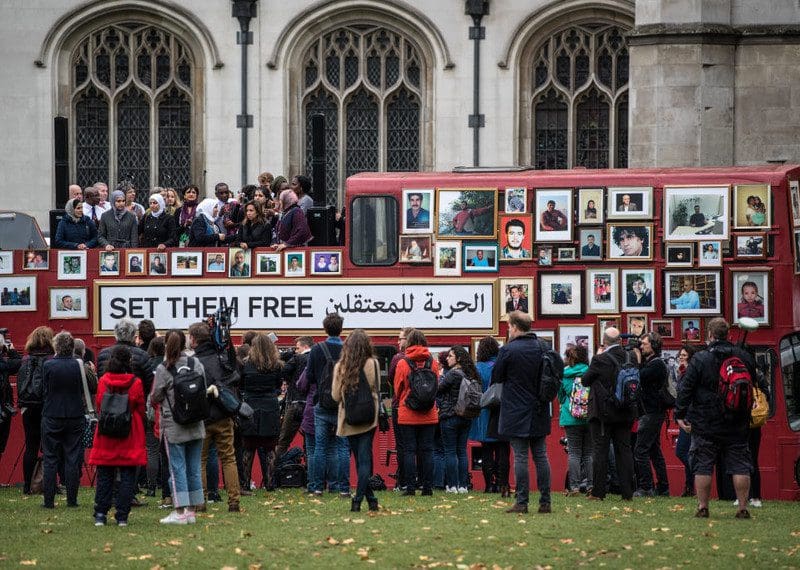 Photographs of missing Syrians are displayed as people, including a group of Syrian women, stand atop a double-decker bus during a demonstration by ‘Families for Freedom’ in Parliament Square in London, England. The protest is part of a woman-led campaign for the rights of those missing in Syria.