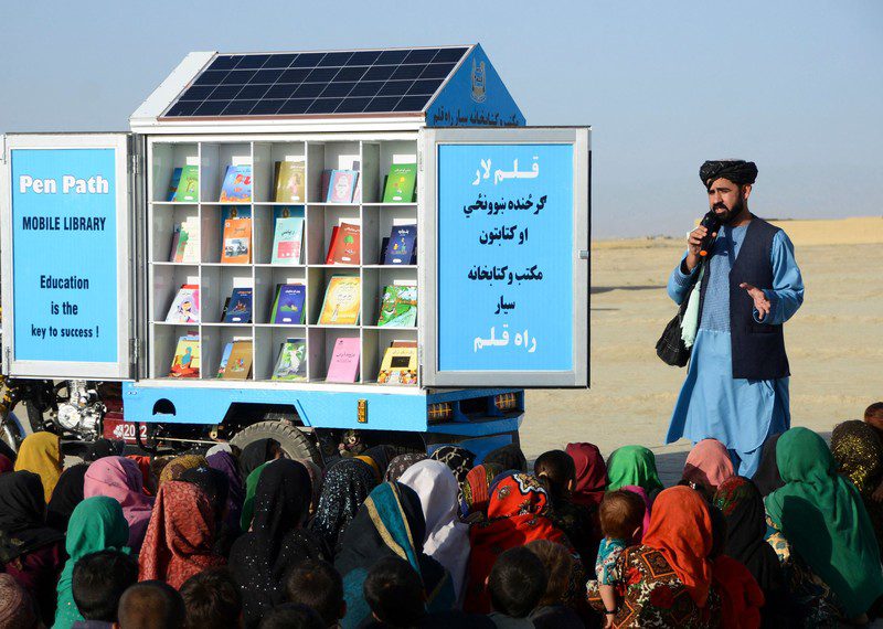 Matiullah Wesa, head of PenPath and advocate for girls’ education in Afghanistan, speaks to children during a class next to his mobile library in Spin Boldak district of Kandahar Province. Wesa, the founder of a project that campaigned for girls’ education in Afghanistan, was detained by Taliban authorities in Kabul for his work.