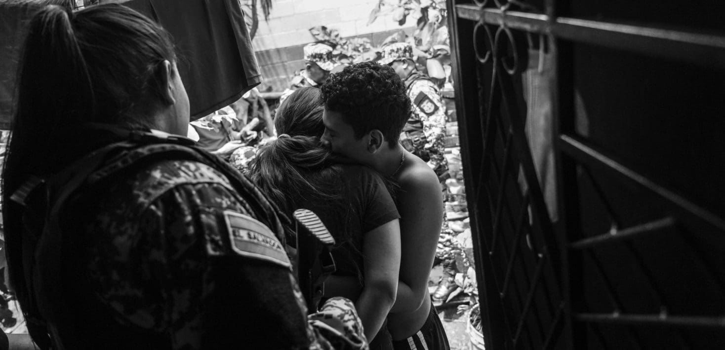 Couple hugs in doorway in El Salvador building