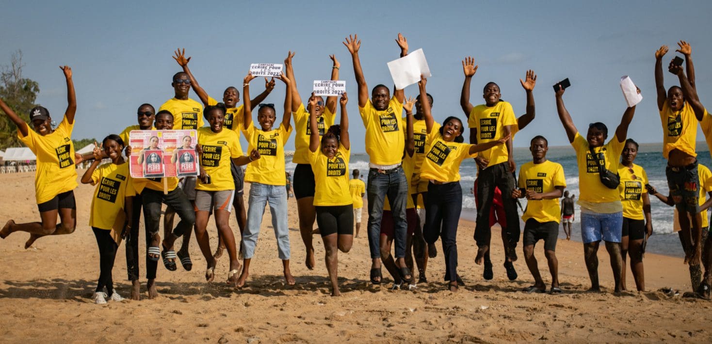 Group of people jumping for joy on a beach