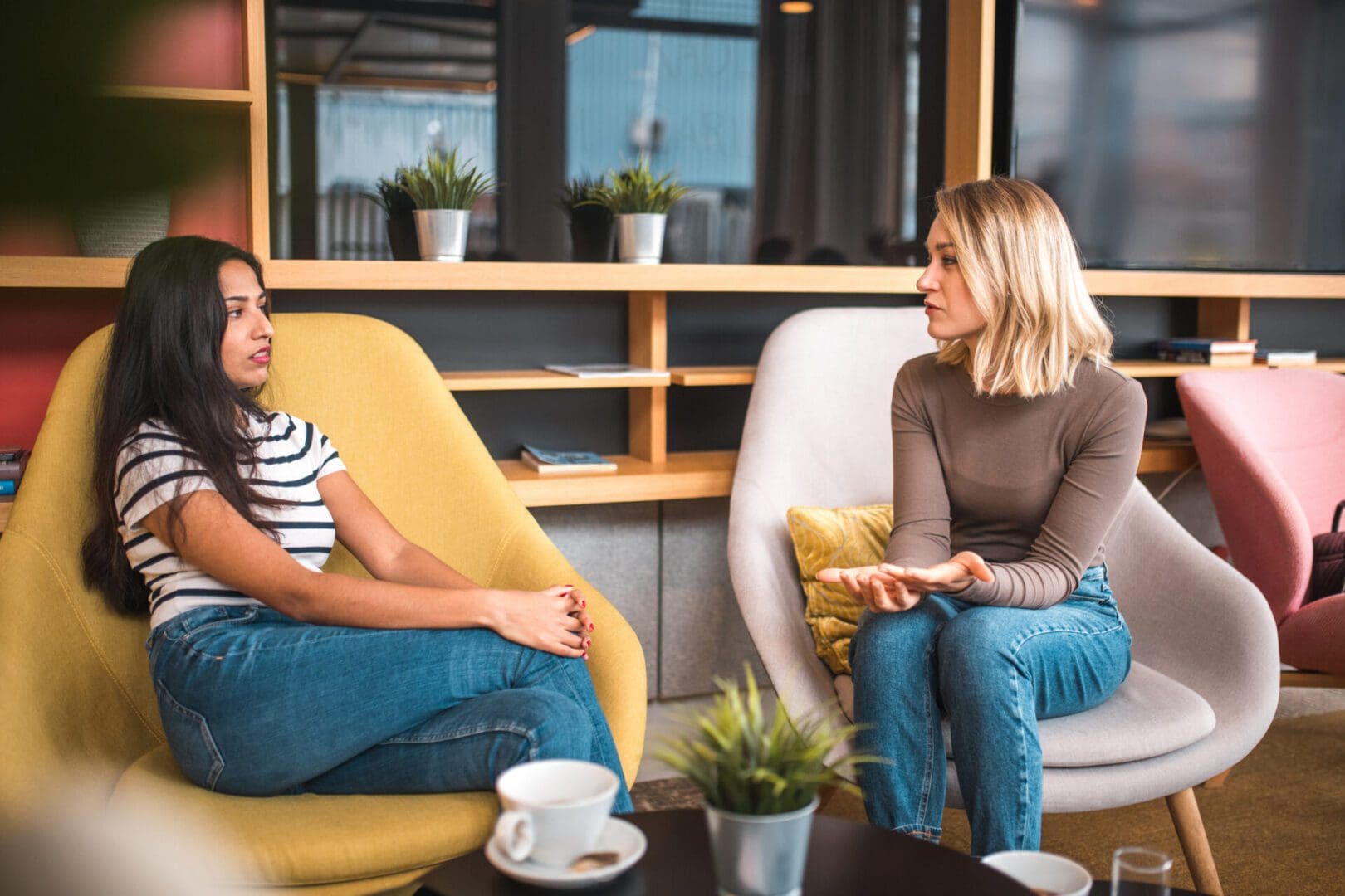 Diverse female friends catching up in a cafe. Spending time together drinking coffee and catching up.