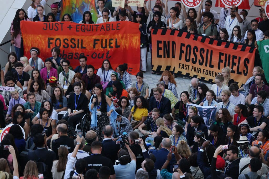 DUBAI, UNITED ARAB EMIRATES - DECEMBER 12: Climate activists protest to demand a phase out of fossil fuels on day twelve at the UNFCCC COP28 Climate Conference on December 12, 2023 in Dubai, United Arab Emirates. Delegations met late into the night yesterday and are continuing negotiations today over the wording of the final agreement, with the removal of a 