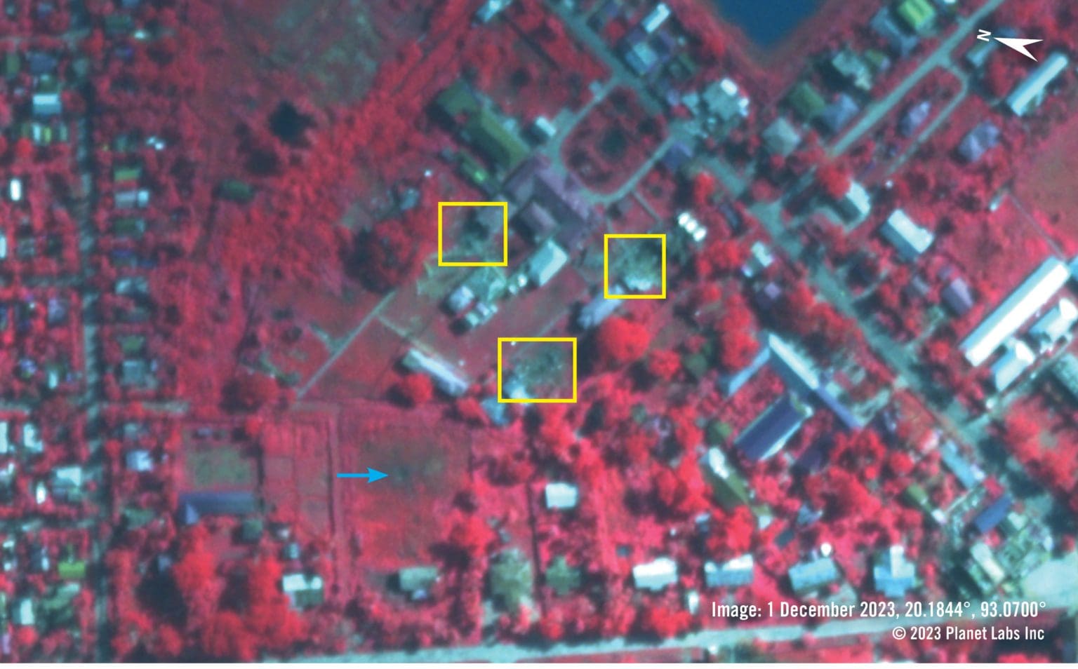 False-colour, near-infrared satellite imagery from 1 December 2023 shows the reported hospital area. Healthy vegetation appears in shades of red and unhealthy or burned vegetation appears darker shades of black and brown. The imagery shows recently damaged and destroyed structures – highlighted with yellow boxes. A large crater, with an approximately four-metre diameter, is highlighted with a blue arrow