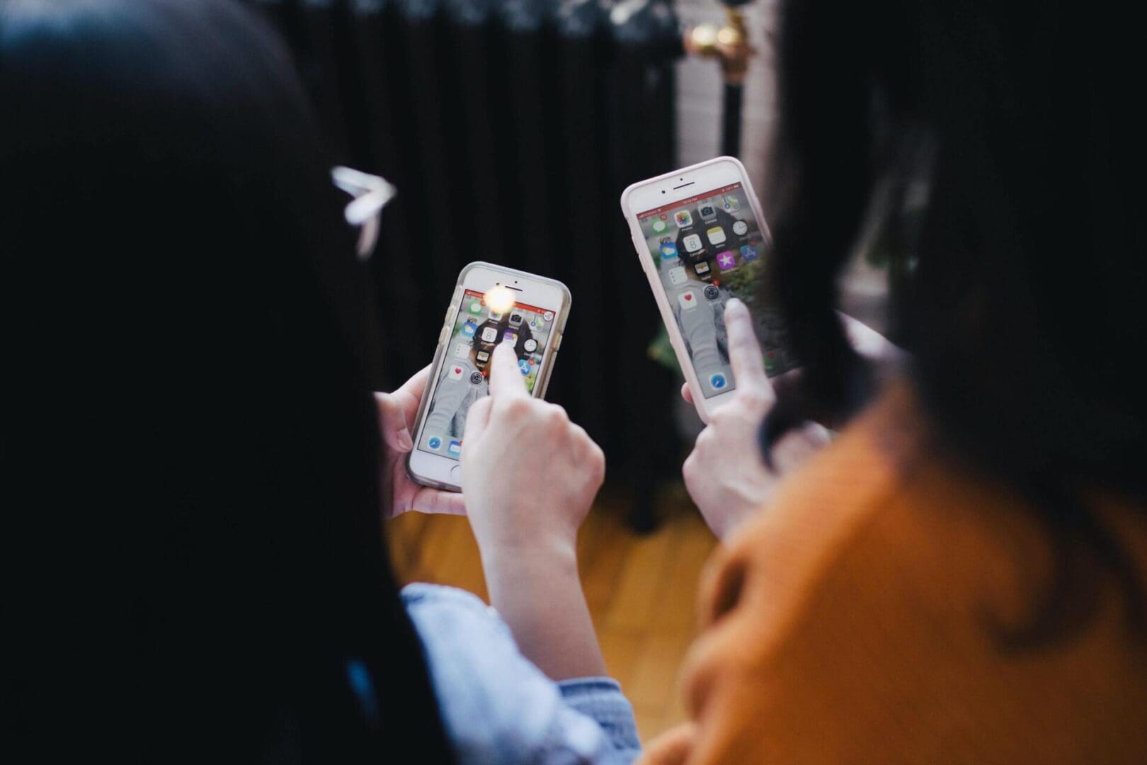 two people look at social media on their phones