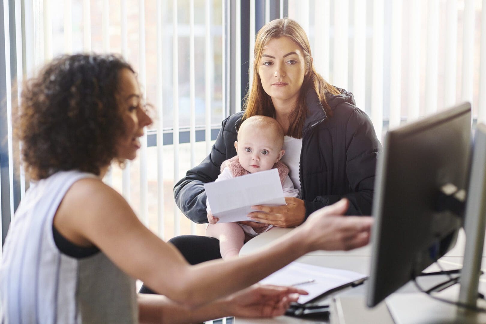 young mother with social services or housing officer