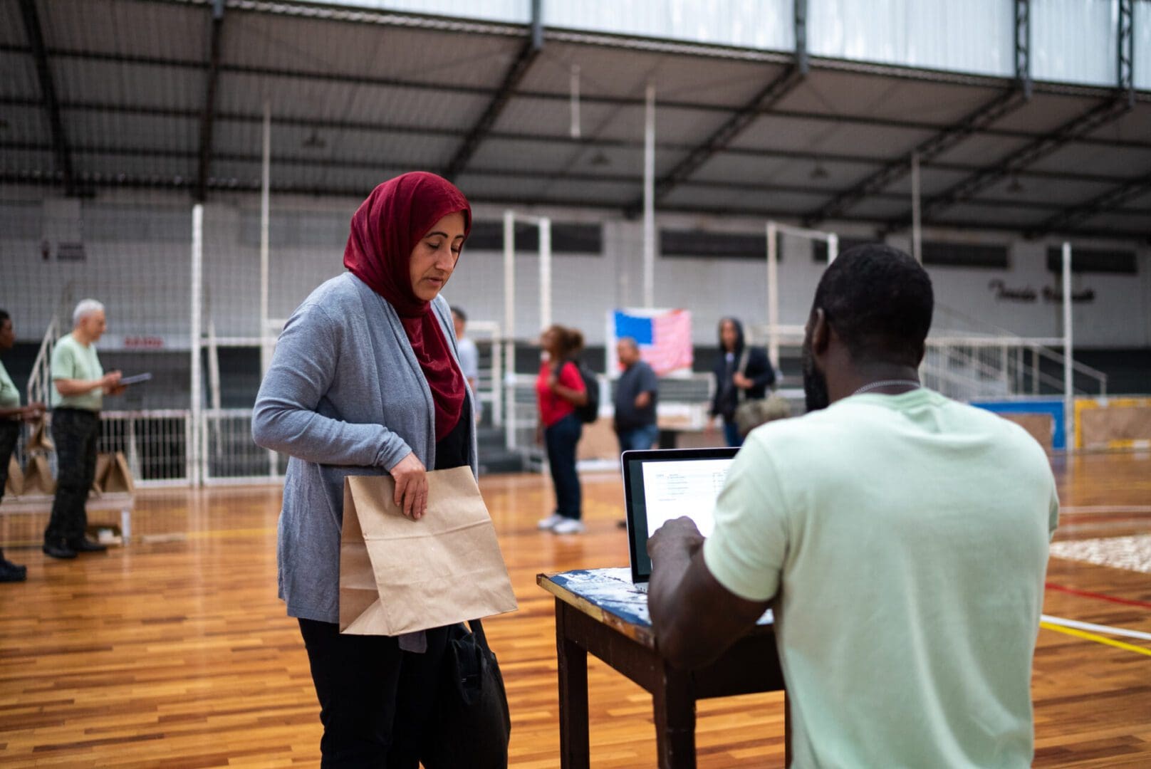 Mature middle eastern woman registering with a soldier at a community center