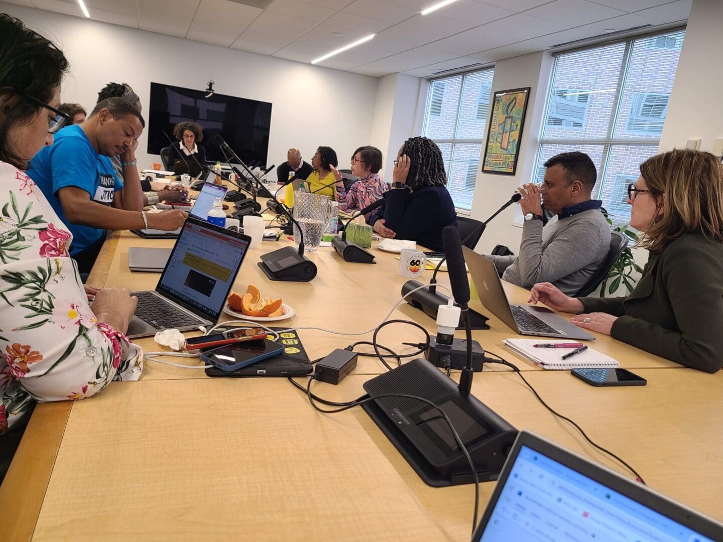 Amnesty Mexico’s Executive Director Edith Olivares (top right, in pink shirt) shares reflections at a roundtable discussion at the AIUSA office.