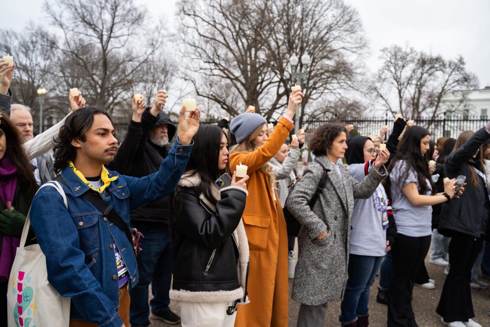 Amnesty International USA protesters hold candles at White House