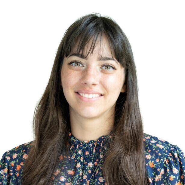 Emily Kramer is pictured wearing a navy blouse with a floral design