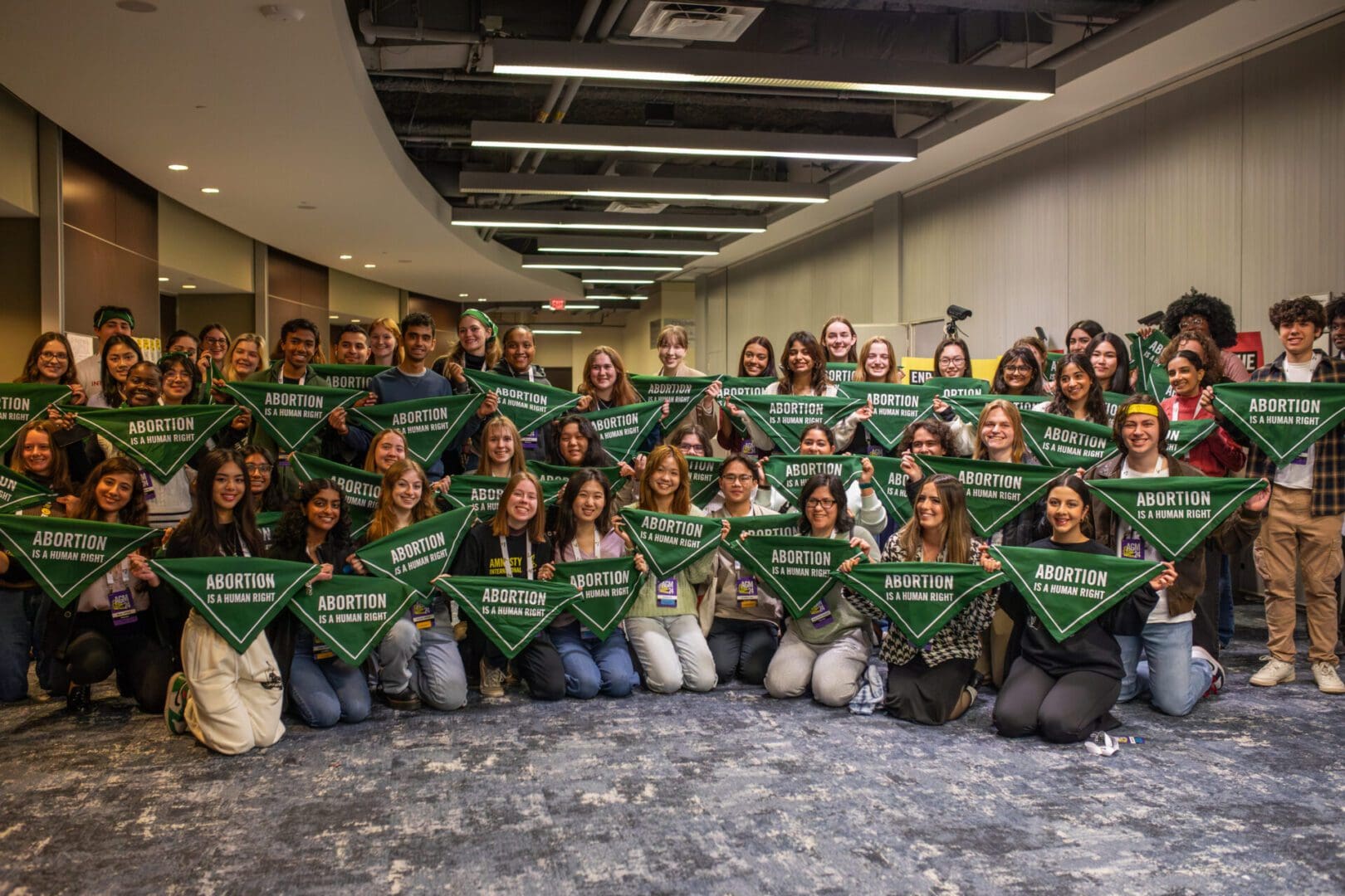 Amnesty International USA AGM participants holding abortion is a human right bandana