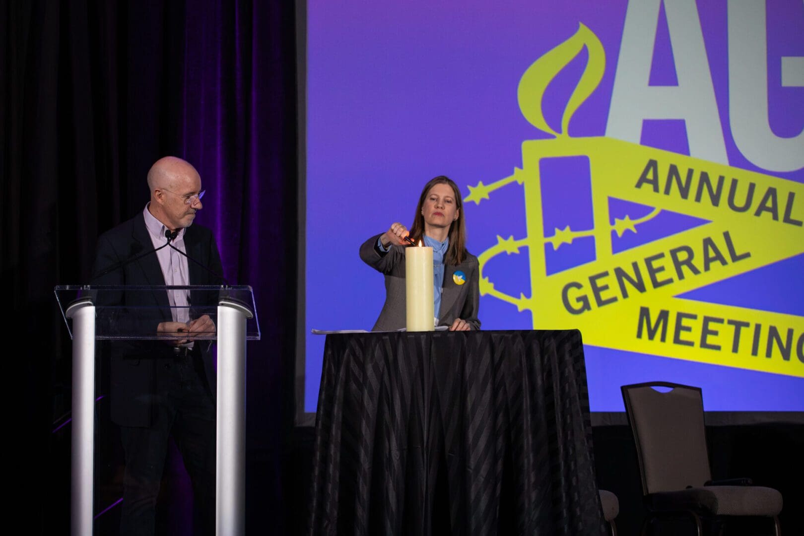 AIUSA Board Chair Alexandra Durbak lit a white candle with Executive Director Paul O’Brien