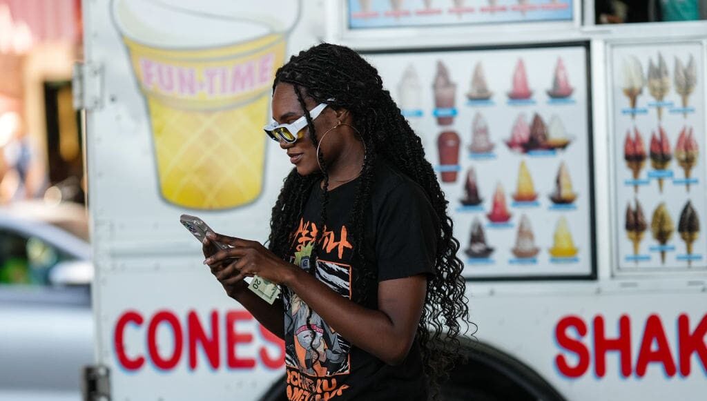 NEW YORK, NEW YORK - SEPTEMBER 10: A guest wears white and yellow sunglasses, gold large earrings, a black with mange print pattern t-shirt, beige / brown / khaki military print pattern cargo pants, outside Jason Wu, during New York Fashion Week, on September 10, 2022 in New York City. (Photo by Edward Berthelot/Getty Images)