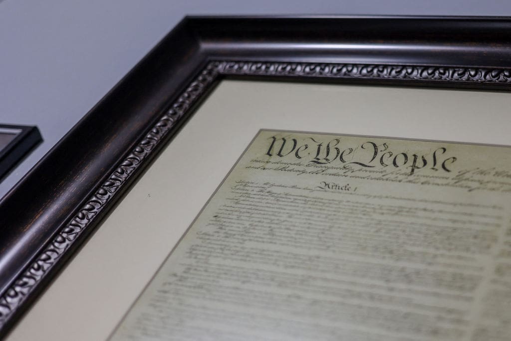 A framed copy of the US constitution hangs in the home of a supporter of former US President and Republican Presidential candidate Donald Trump in Horicon, Wisconsin on November 4, 2024. Bitter rivals Kamala Harris and Donald Trump embark on a final frenzied campaign blitz Monday with both hitting must-win Pennsylvania on the last day of the tightest and most volatile US presidential election in memory. (Photo by Alex Wroblewski / AFP) (Photo by ALEX WROBLEWSKI/AFP via Getty Images)