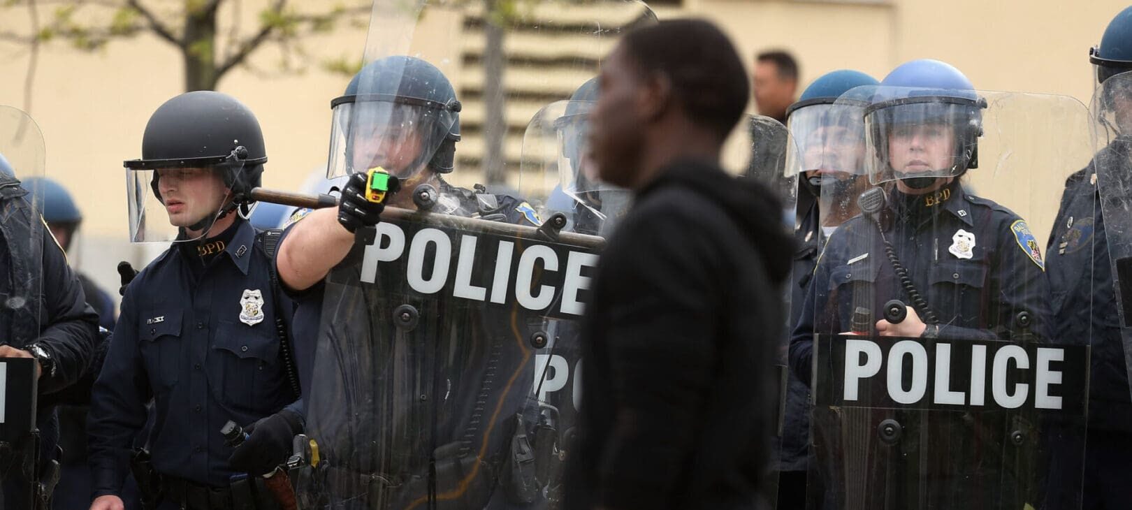 BALTIMORE, MD - APRIL 27: A Baltimore Police officer aims his taser at a demonstrator outside the Mondawmin Mall following the funeral of Freddie Gray April 27, 2015 in Baltimore, Maryland. Gray, 25, who was arrested for possessing a switch blade knife April 12 outside the Gilmor Homes housing project on Baltimore's west side. According to his attorney, Gray died a week later in the hospital from a severe spinal cord injury he received while in police custody. (Photo by Chip Somodevilla/Getty Images)