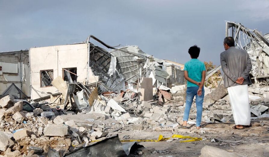 SANA'A, YEMEN - MARCH 20: A man and his son inspect a building targeted by the United States aerial attacks on March 20, 2025, in Sana'a, Yemen. US officials have said airstrikes launched against Yemen’s Iran-backed Houthis will continue indefinitely, after launching strikes on Saturday which aim to punish the Houthis for their attacks against Red Sea shipping. (Photo by Mohammed Hamoud/Getty Images)