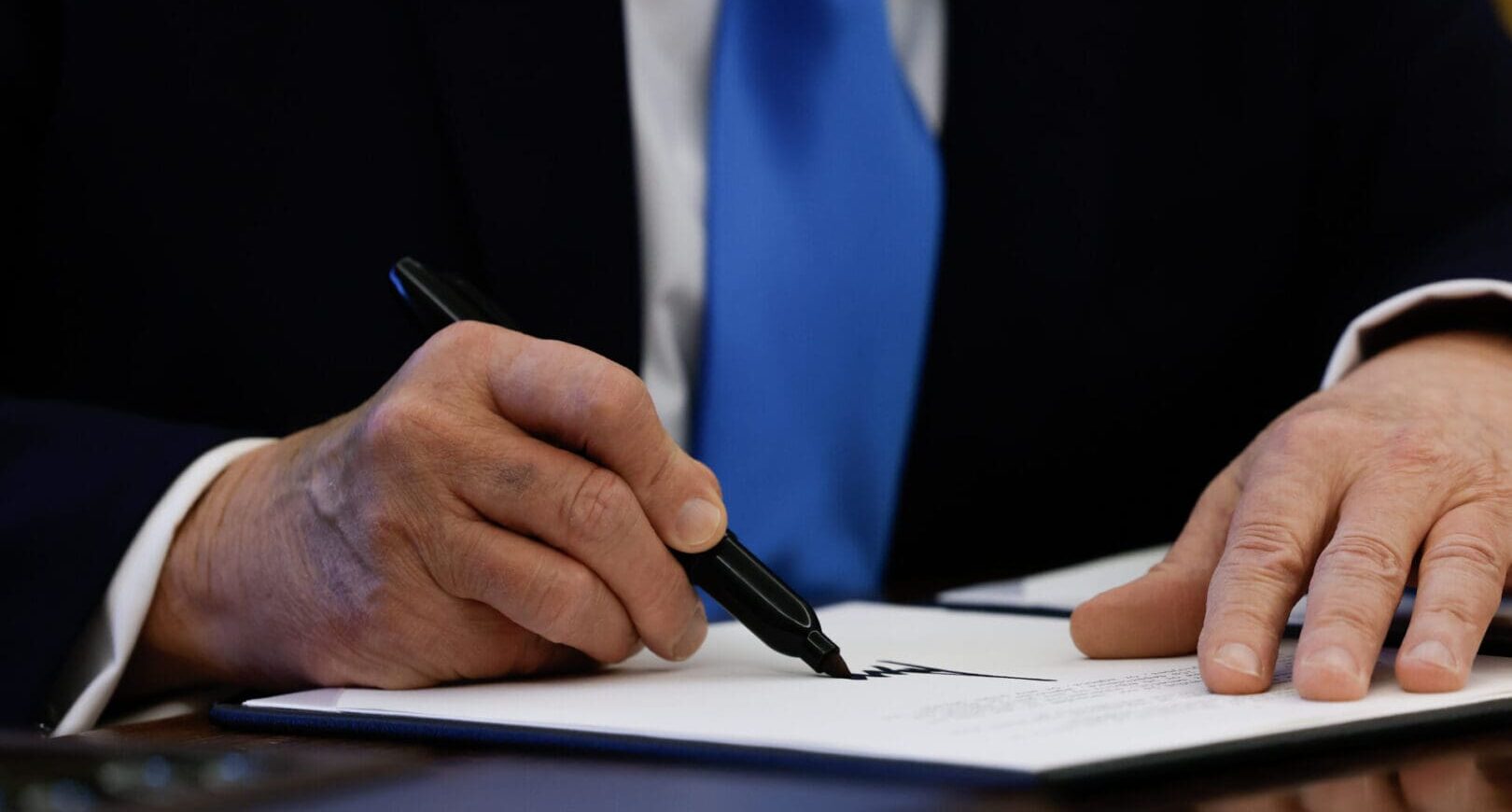 closeup of trump signing executive order