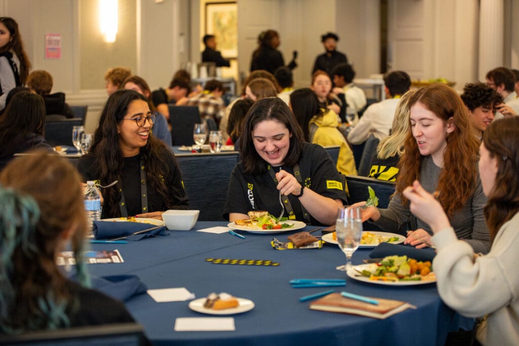 Gauri Bhatia, AIUSA Youth Leadership & Activism Slack Community Manager (pictured on the far left) dines with fellow youth attendees.