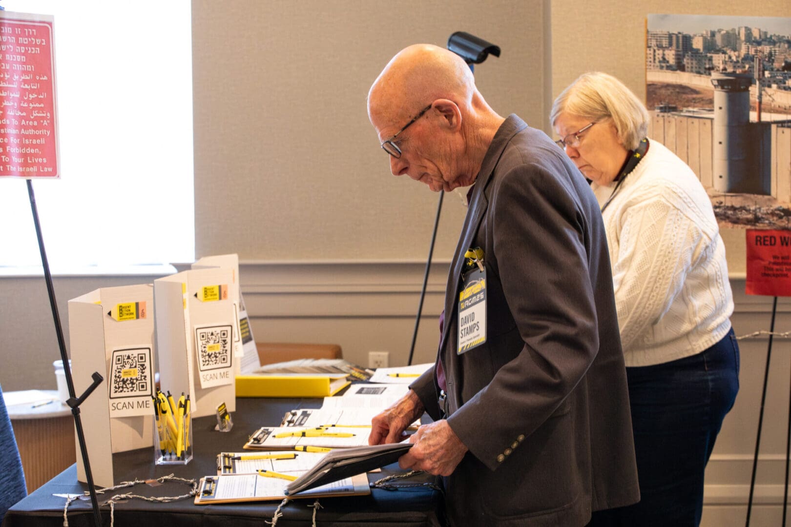AIUSA members at Action Alley filling out forms and reading material.