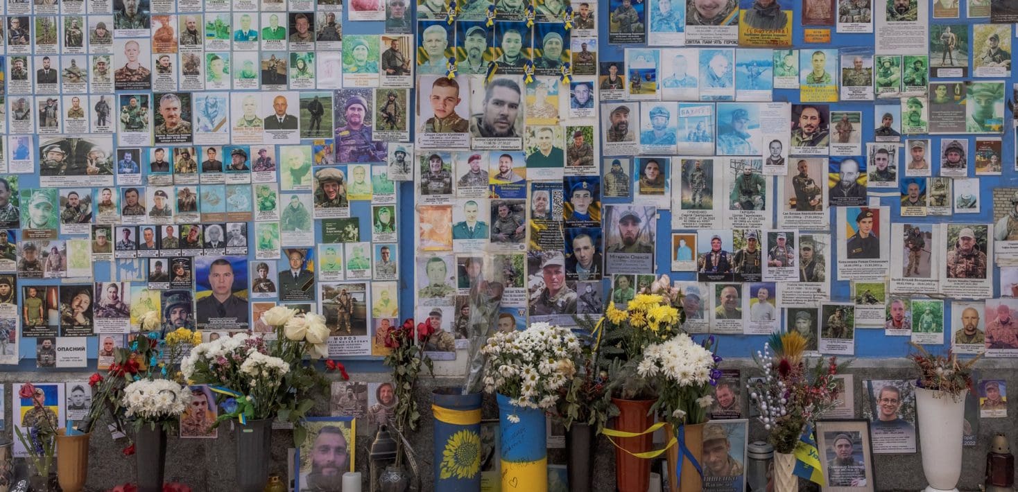 Memorial wall of photos and flowers